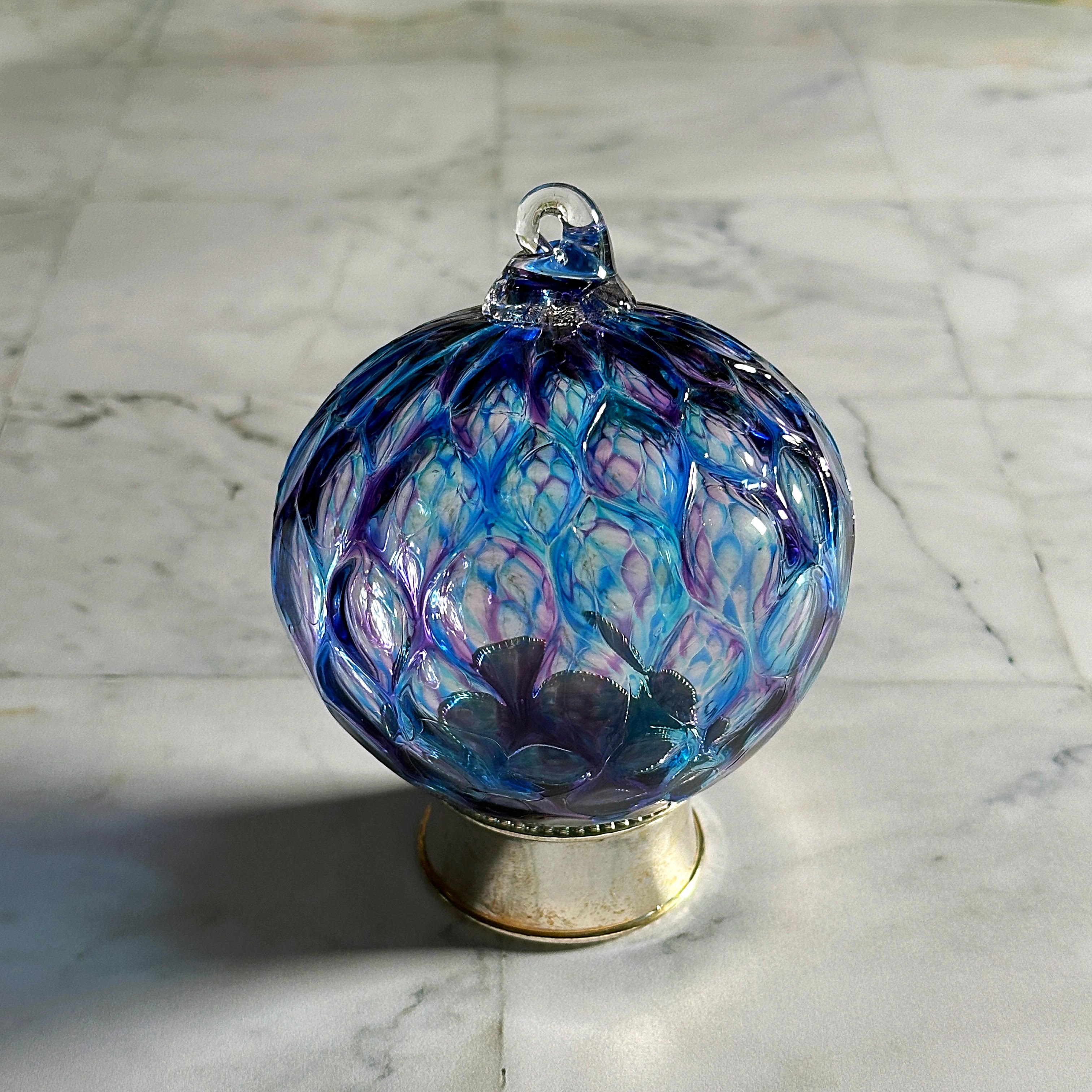 purple and blue diamond carved hand-blown glass ornament on display