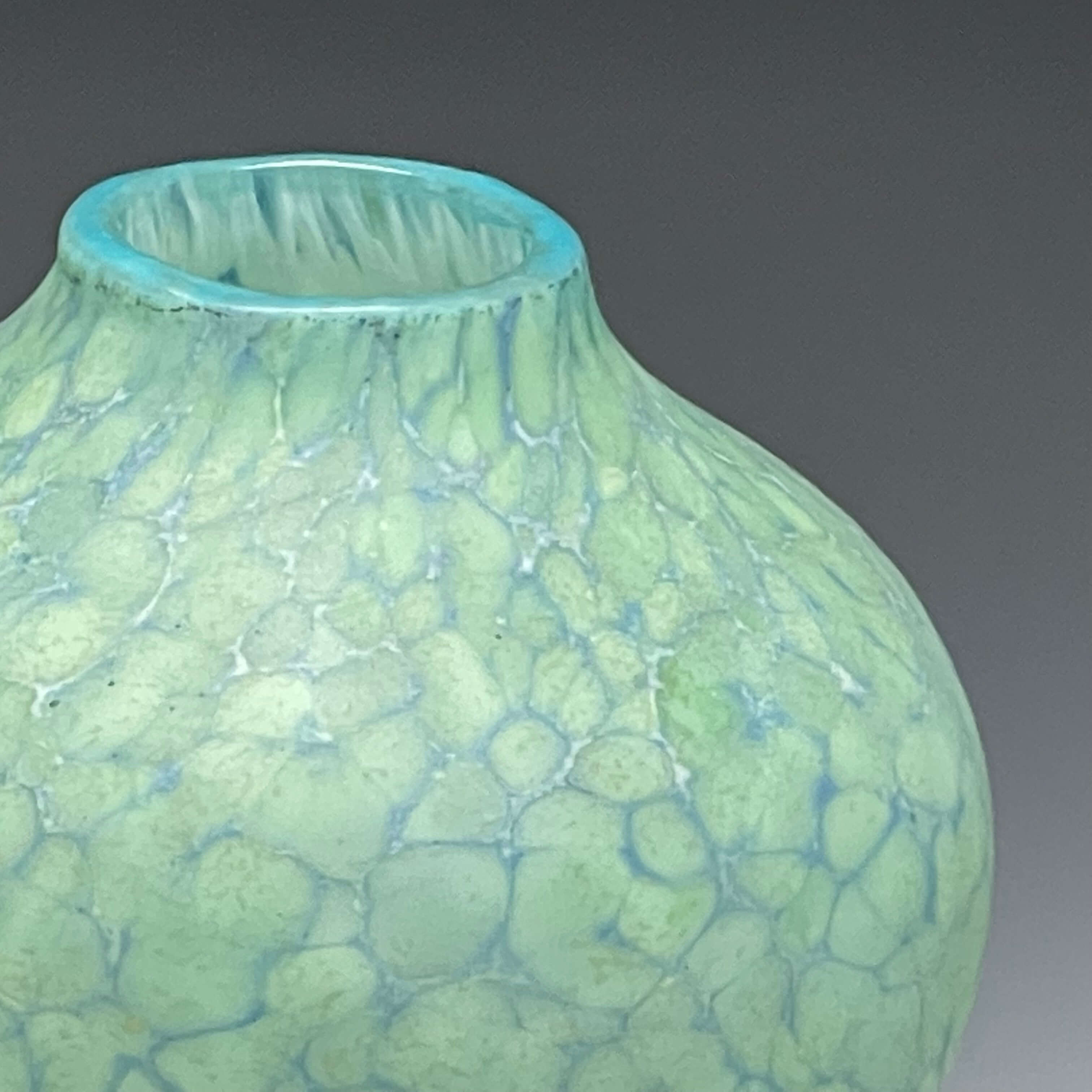 detail of celadon sandblasted blown glass vase.