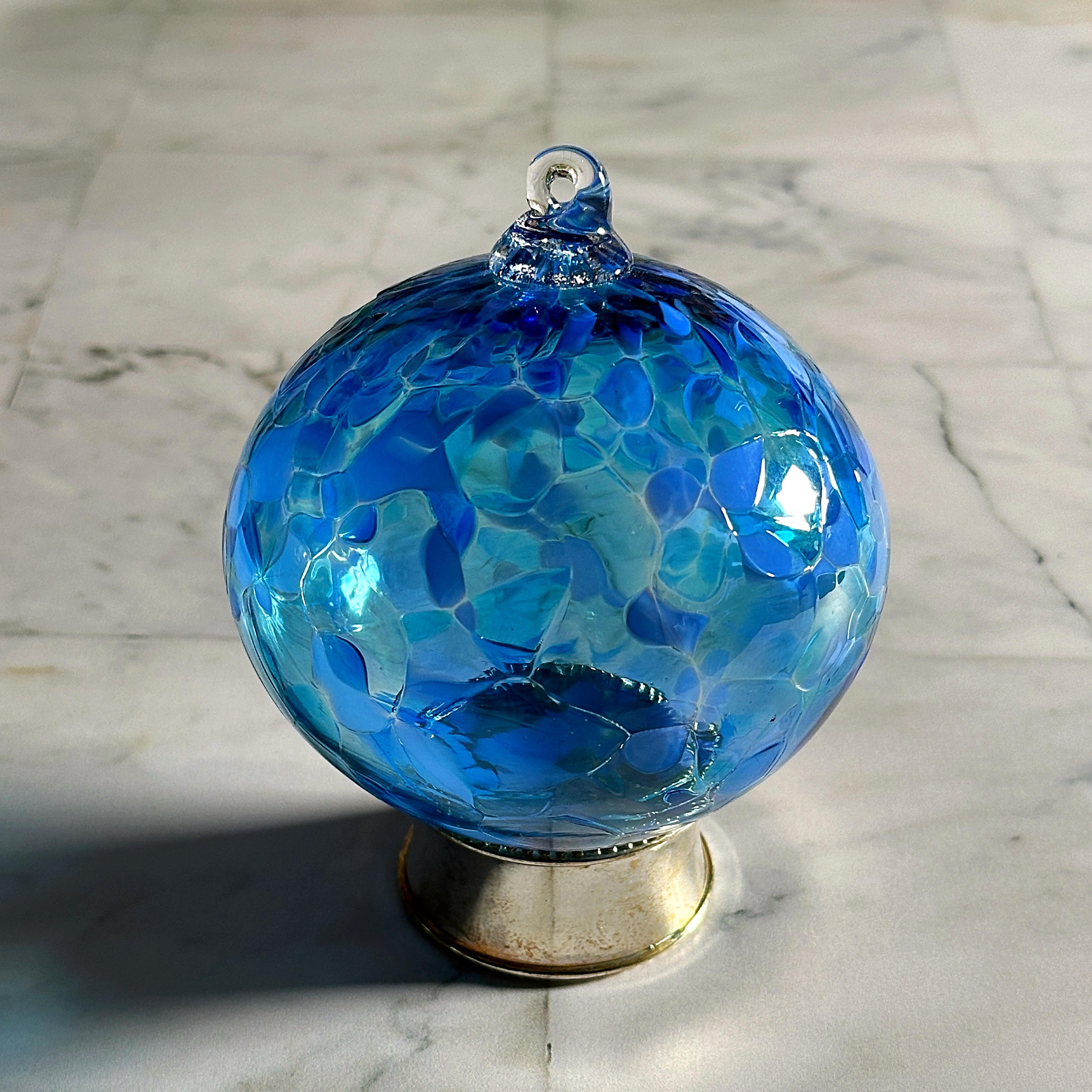 round blue hand-blown glass ornament on display