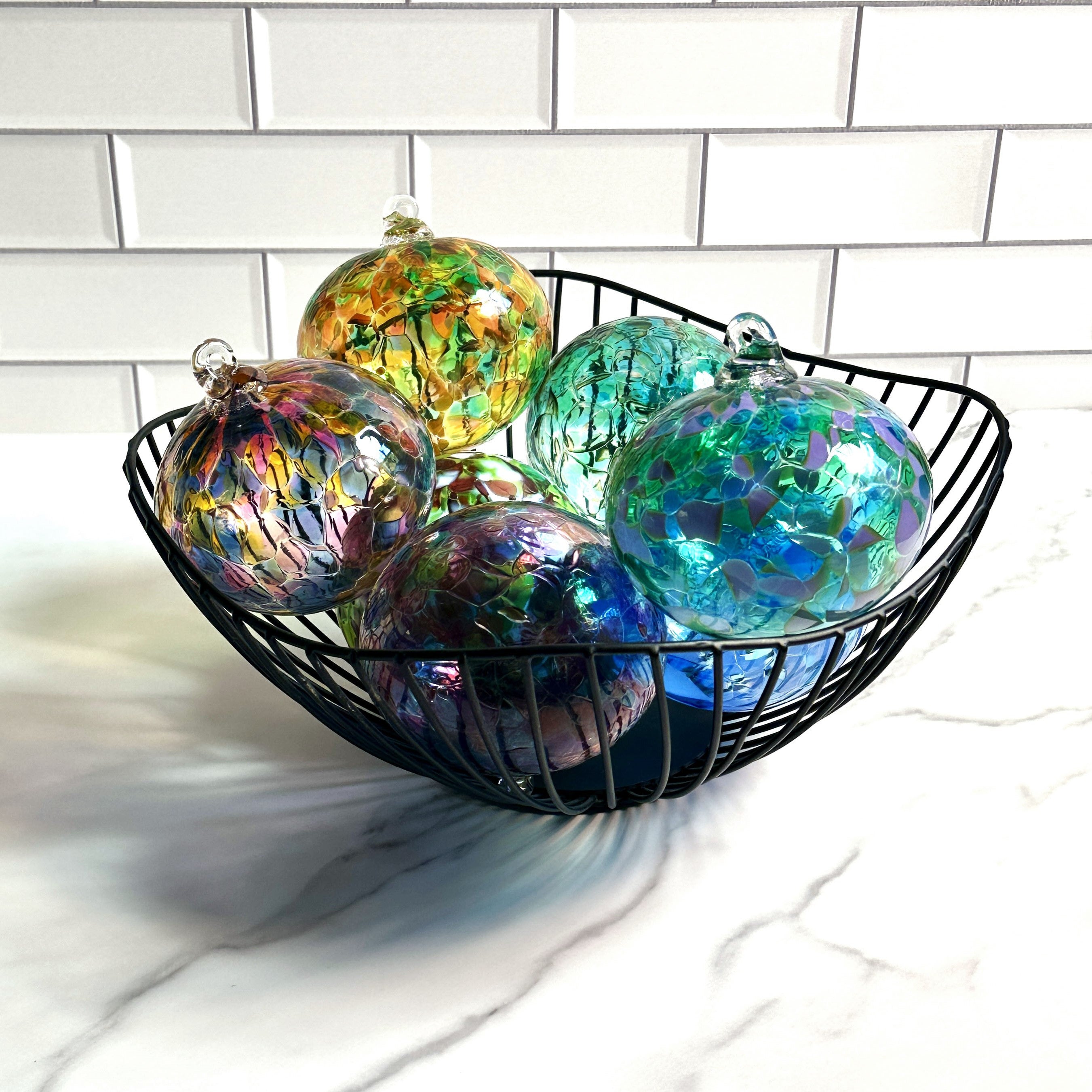 hand-blown glass ornaments in a basket