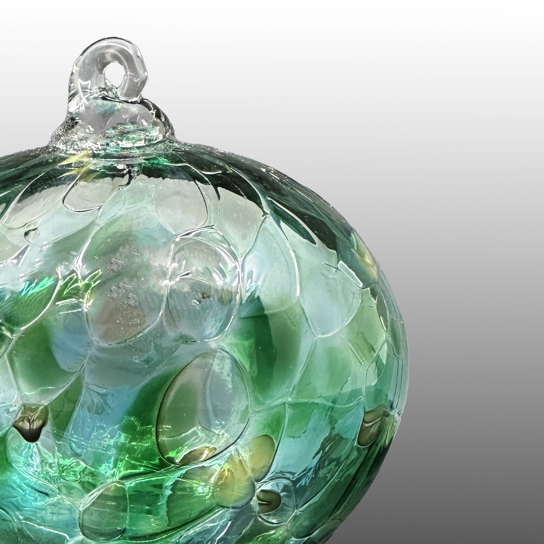 detail of green round hand-blown glass ornament