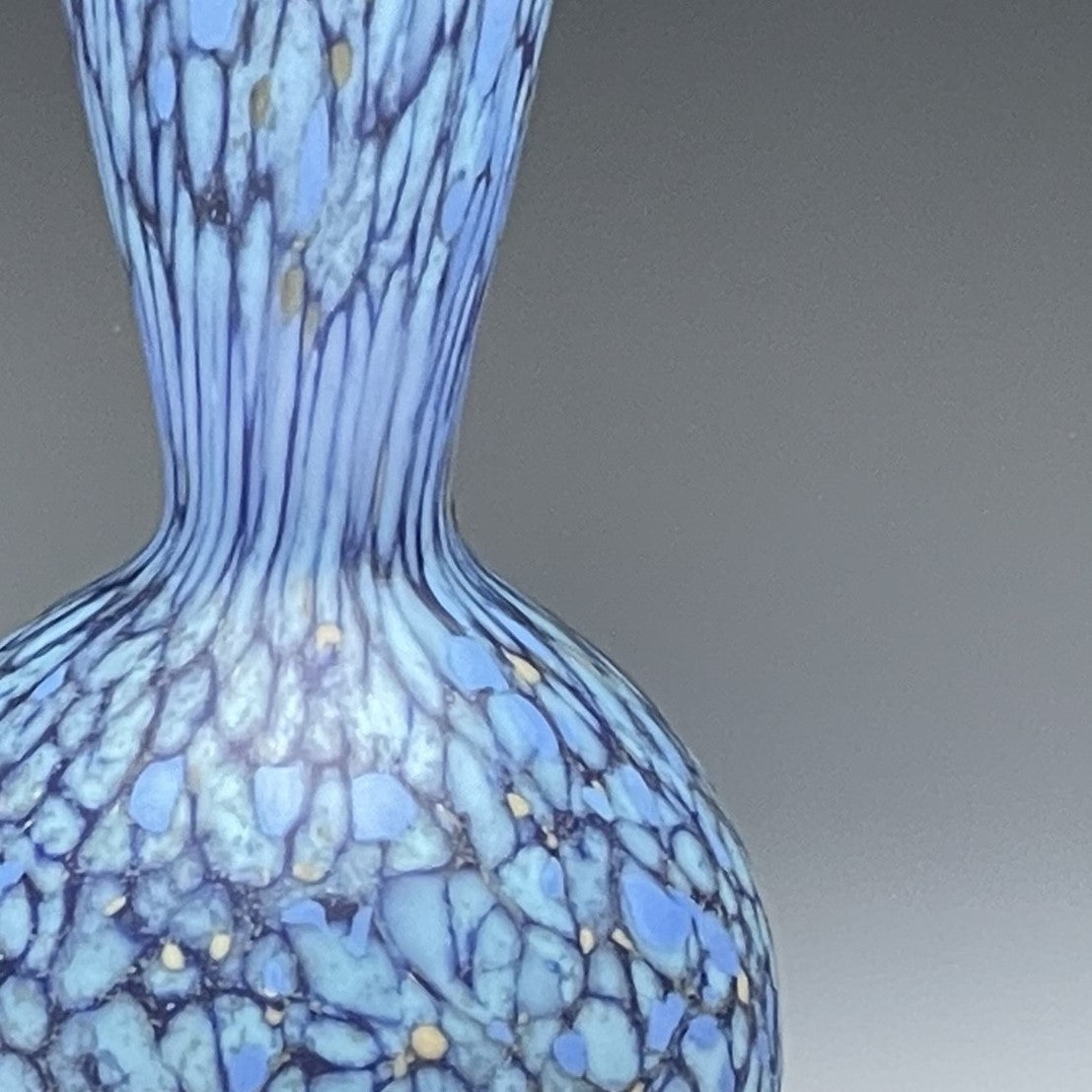 detail of blue hand-blown glass bottle