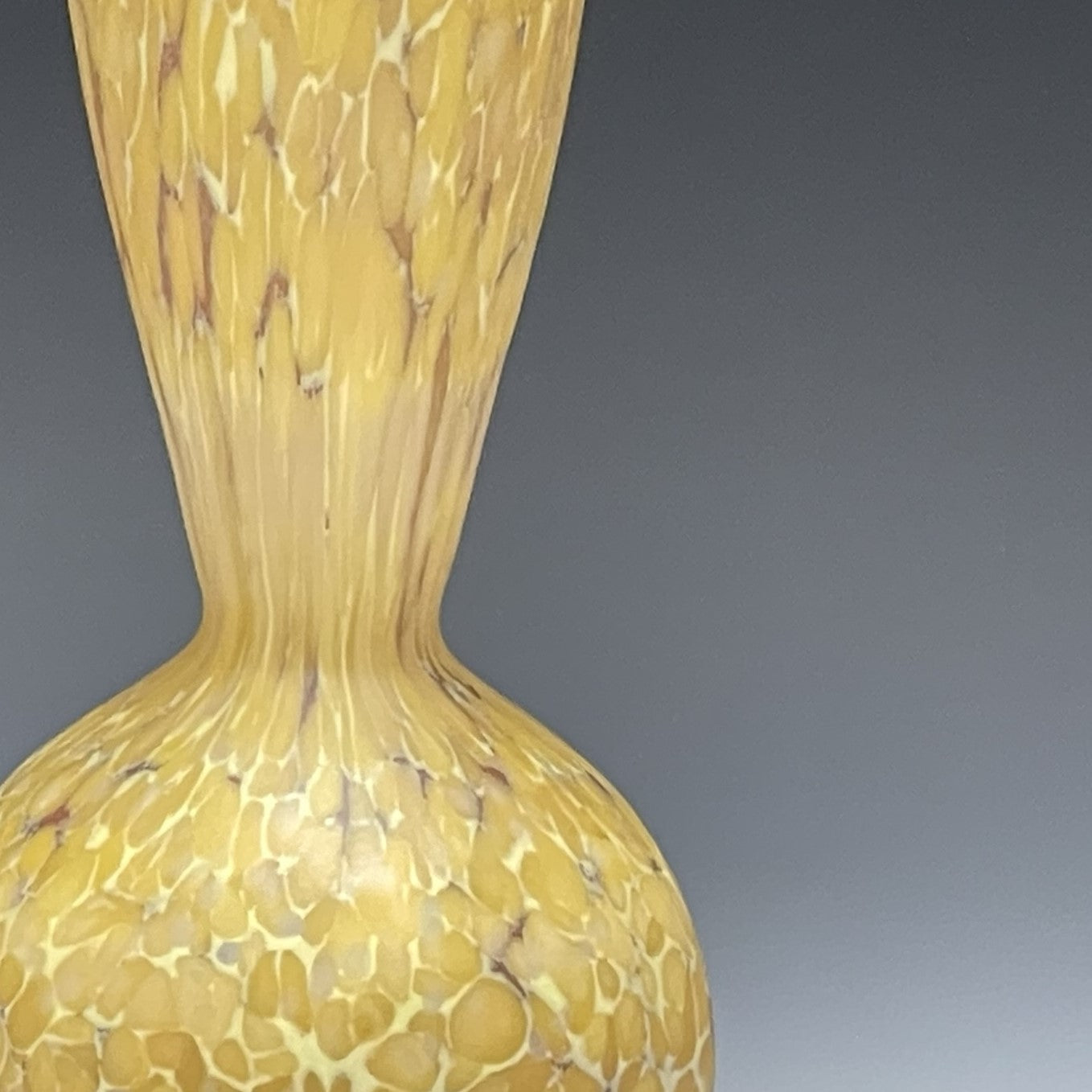 detail of curry blown glass bottle