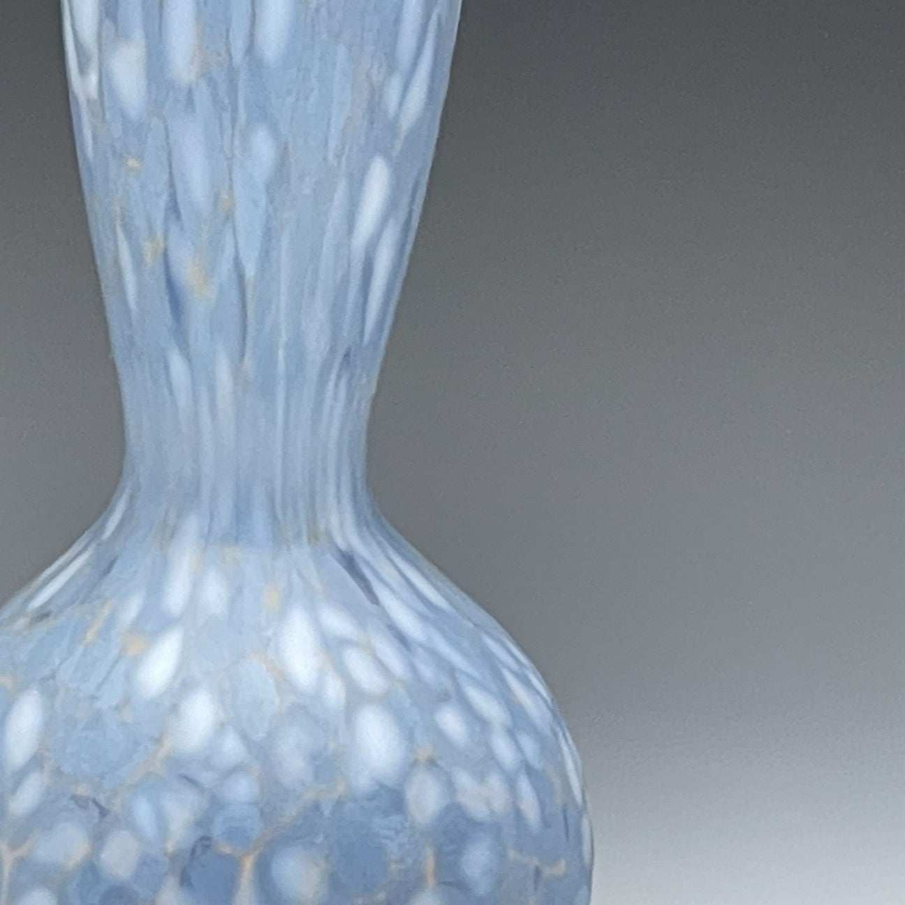 detail of periwinkle blown glass bottle