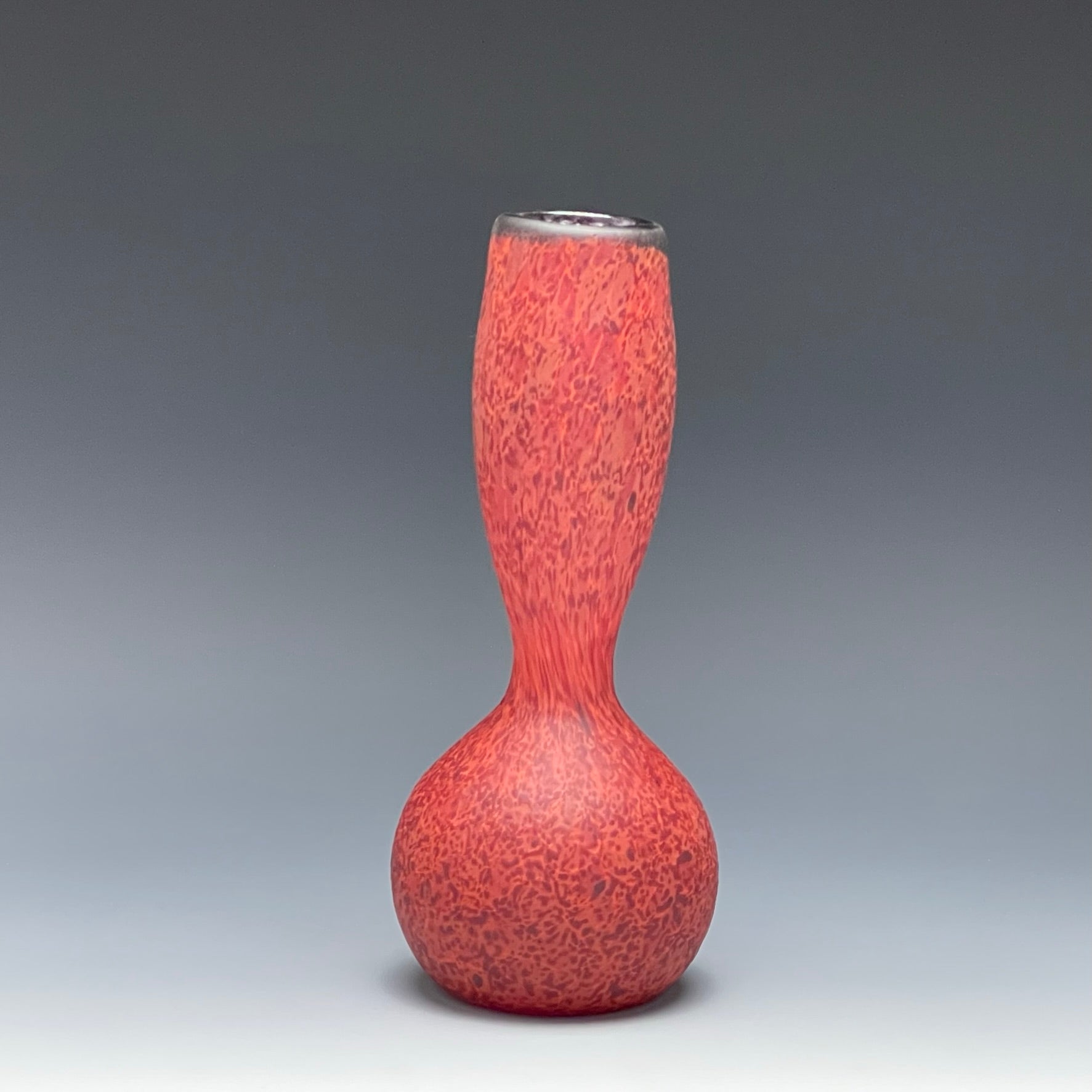 red blown glass bottle