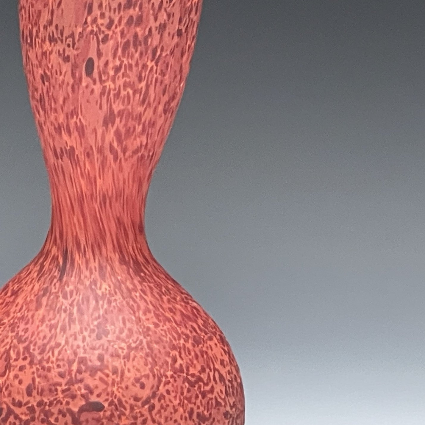 detail of red blown glass bottle