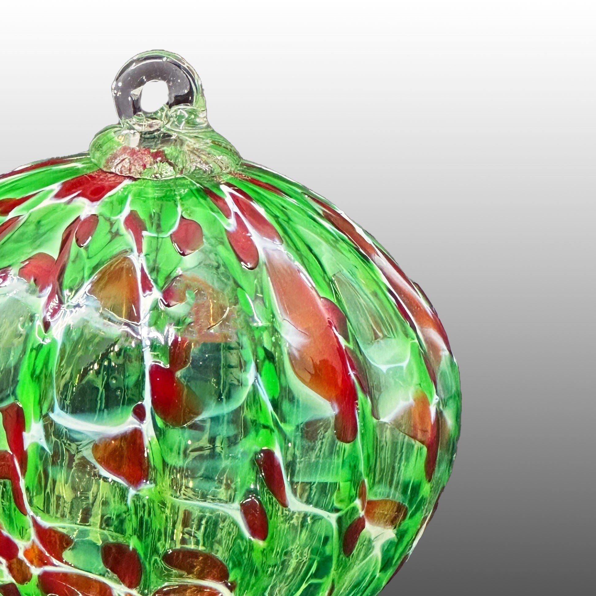 detail of red, white and green ribbed hand-blown glass ornament