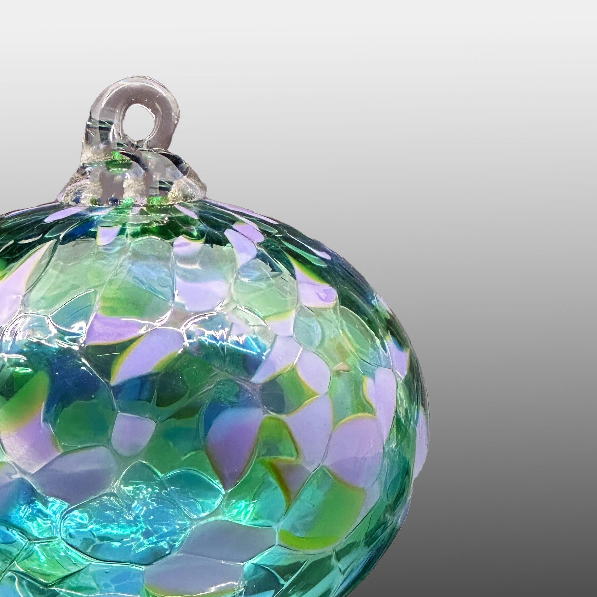 detail of green and lavender round hand-blown glass ornament