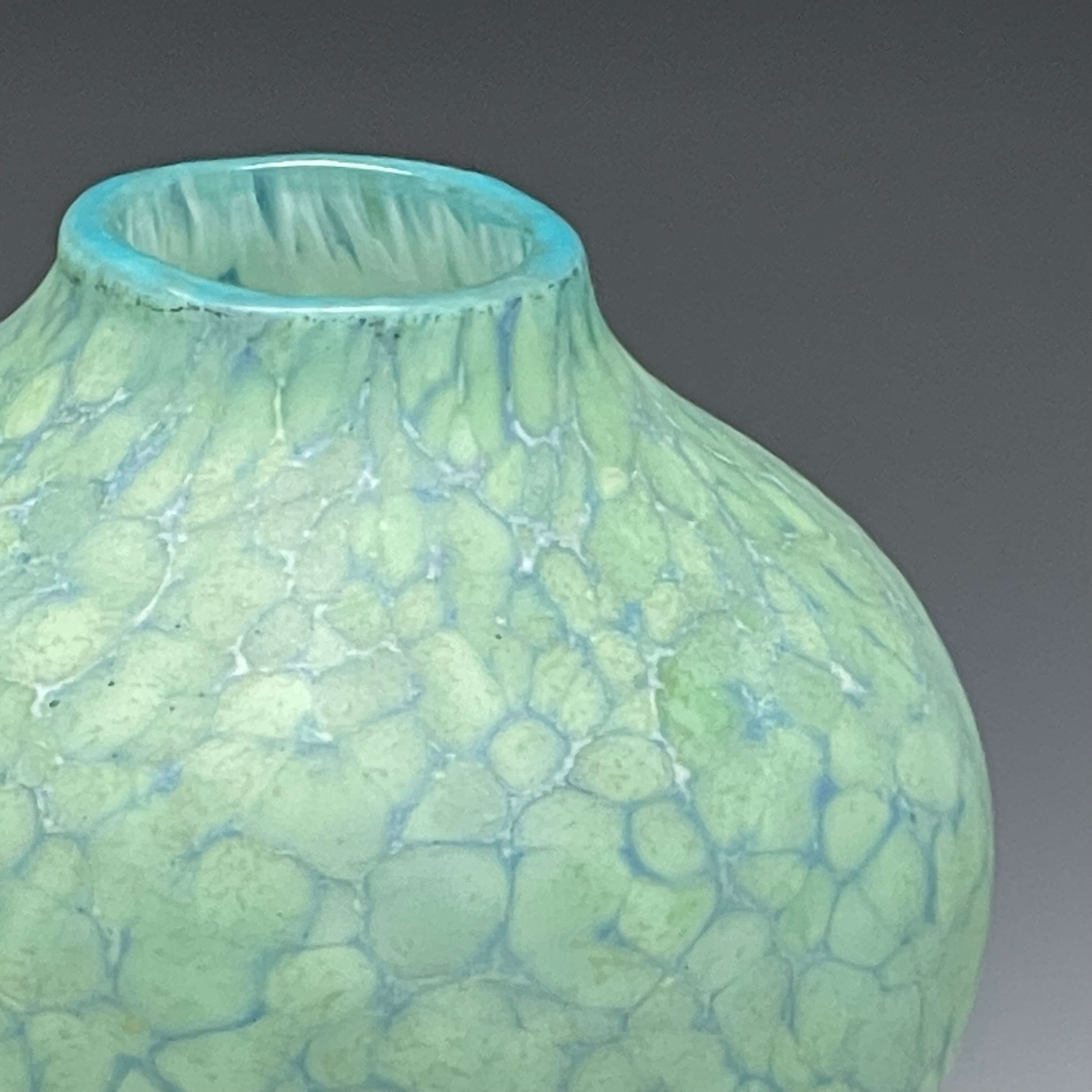 detail of celadon sandblasted blown glass vase.