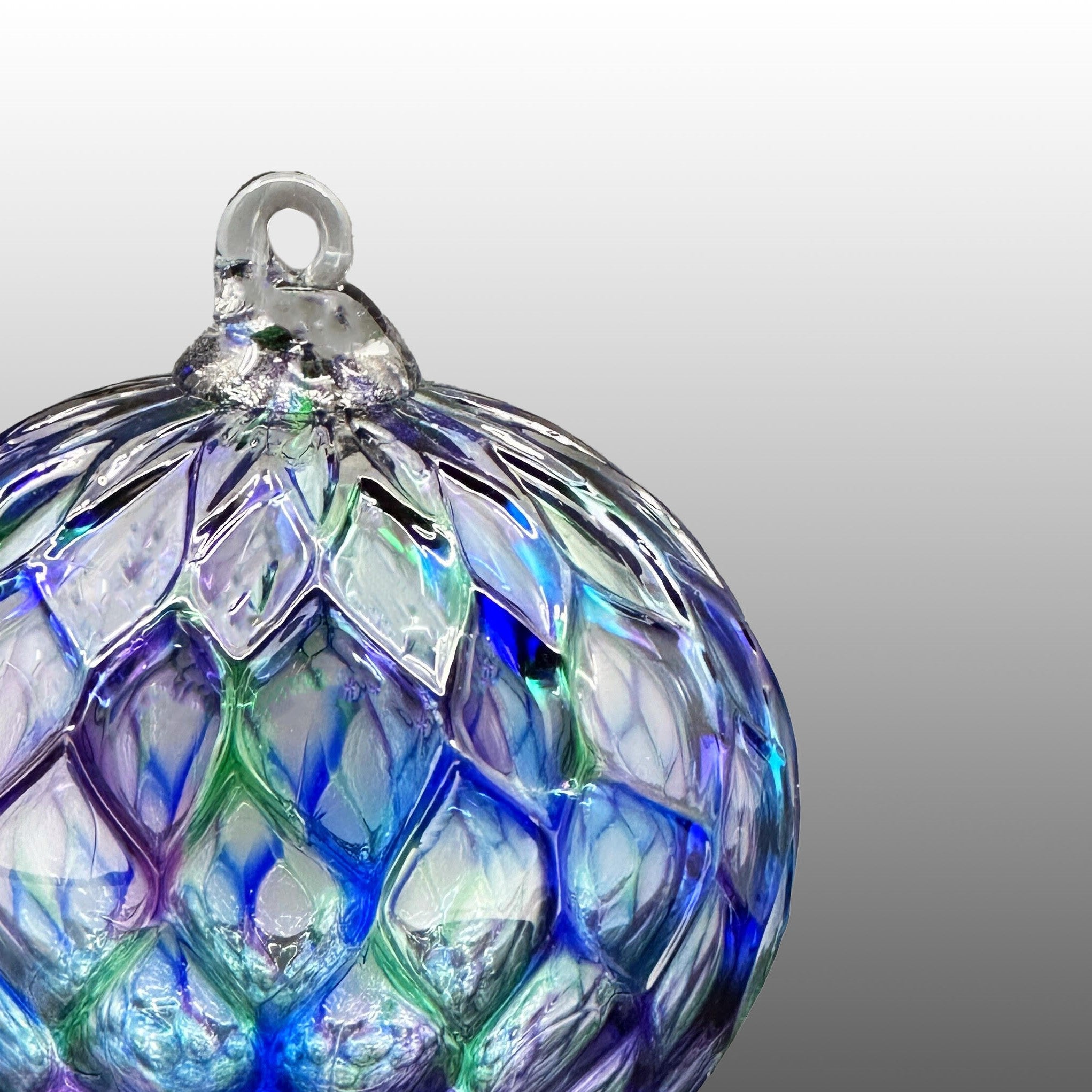 detail of blue, green and purple hand-blown diamond carved glass ornament