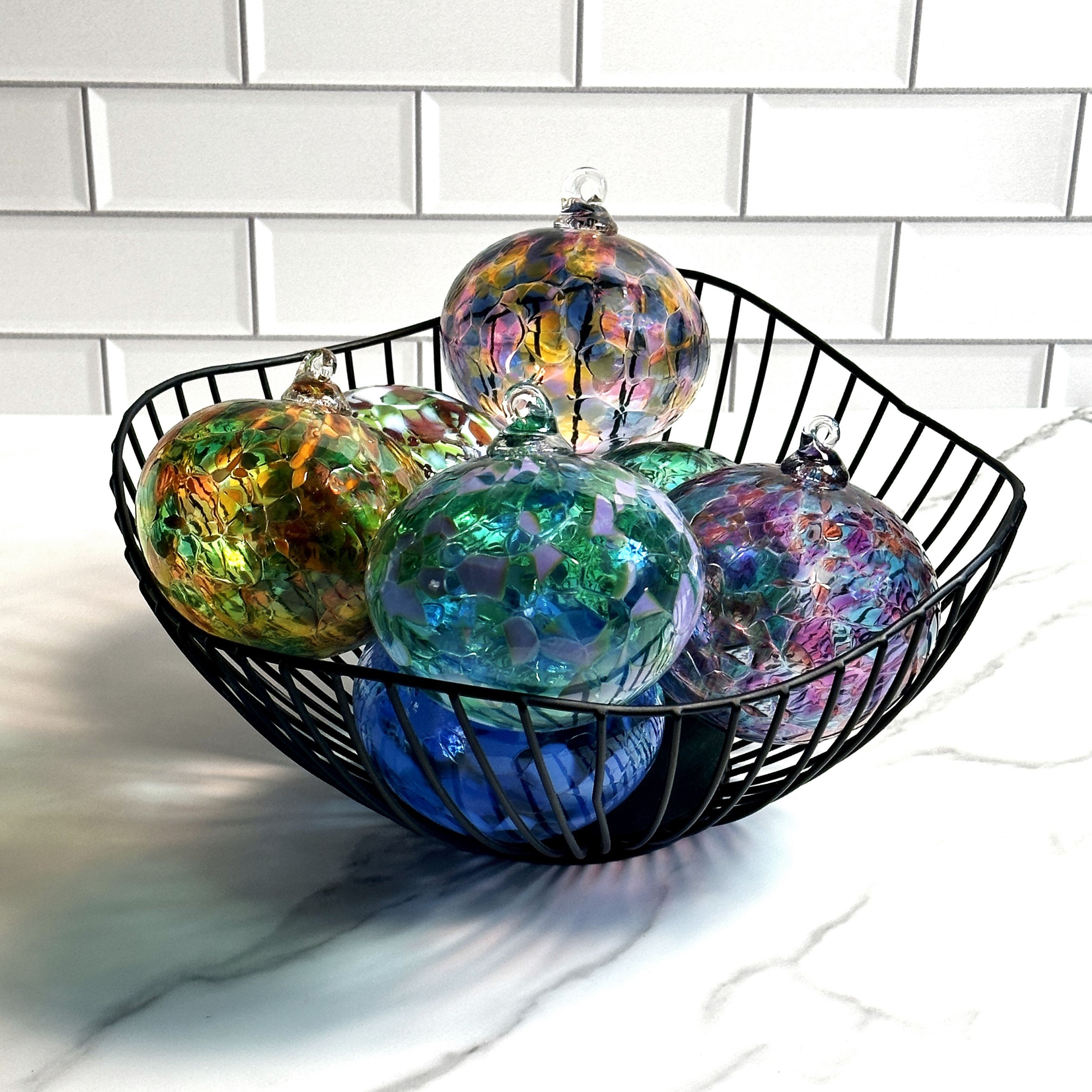 hand-blown glass ornaments in a basket