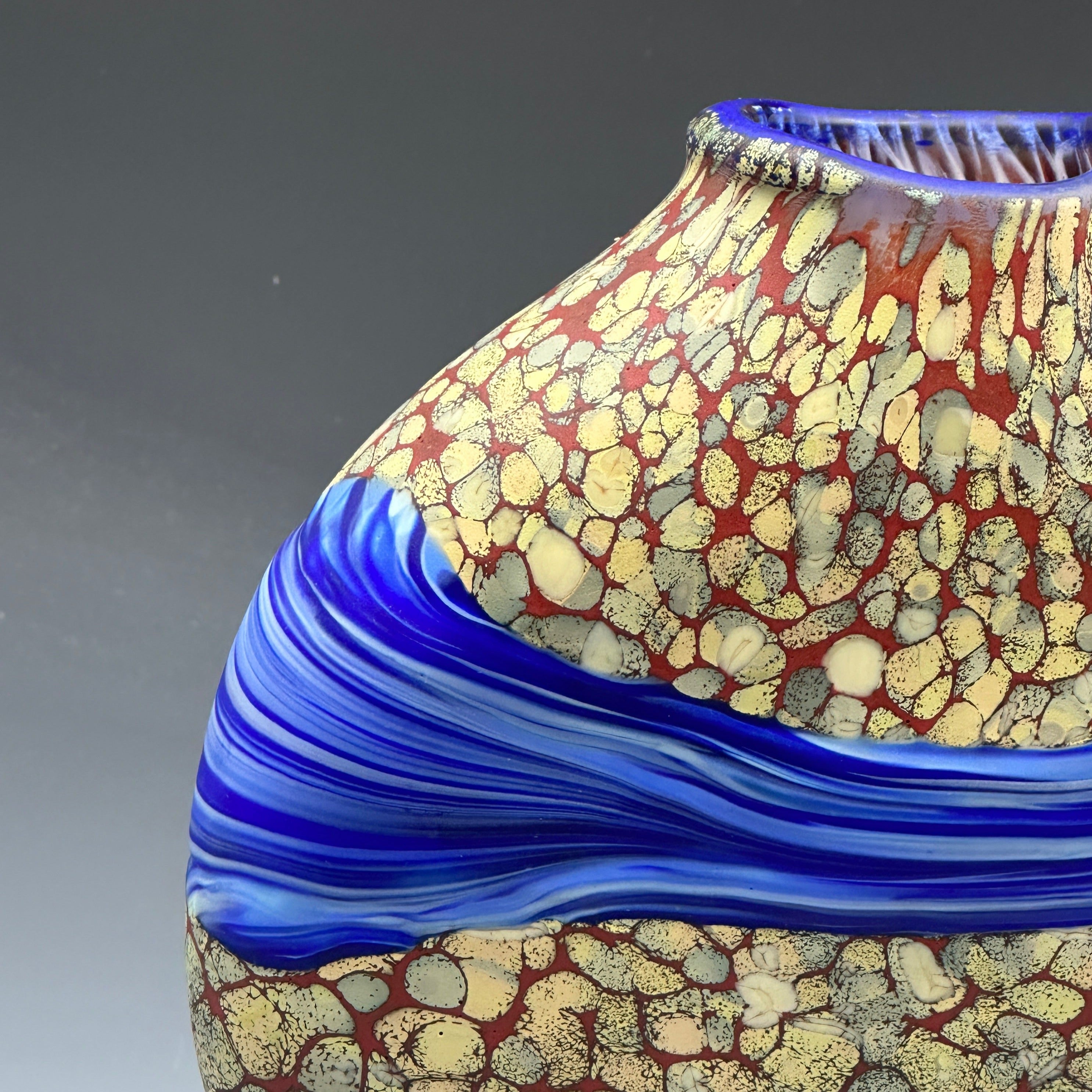 detail of sandy strata vase with blue stripe